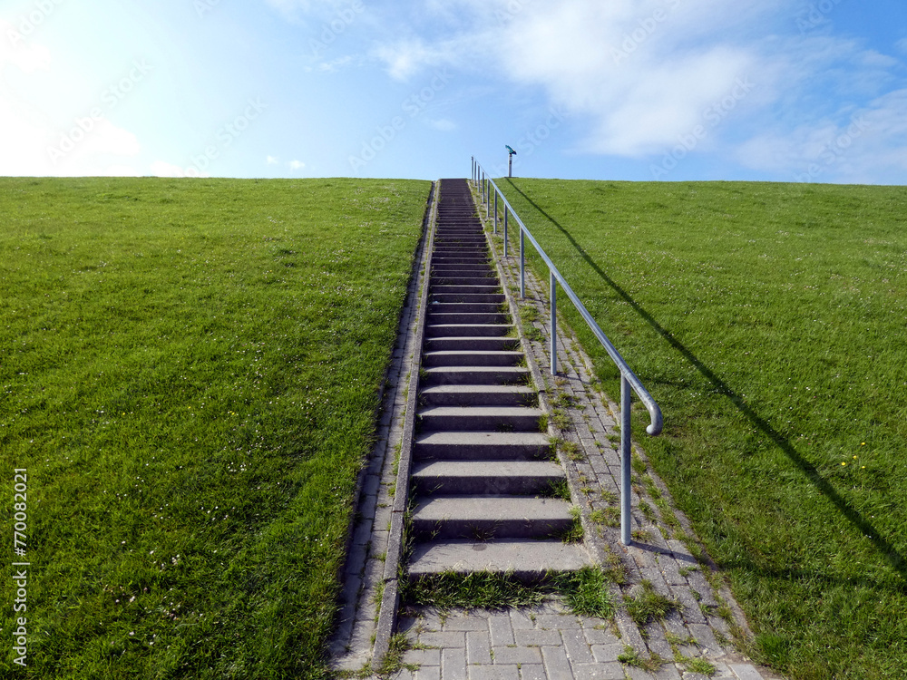 Stairs to the dike and path to the Pilsum lighthouse Stairs to the dike and path to the Pilsum lighthouse