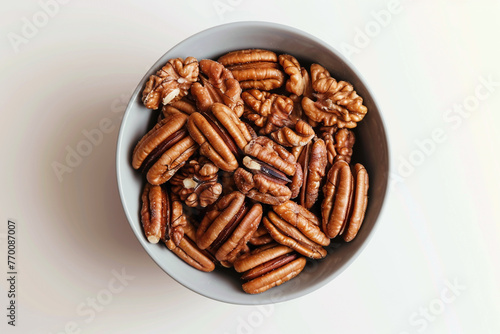 Pecan nuts in bowl on white background. Nutritive foodisolated on solid white background. photo