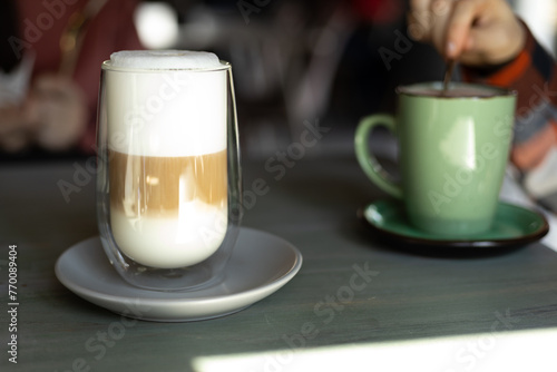 coffee latte in a transparent glass with white foam