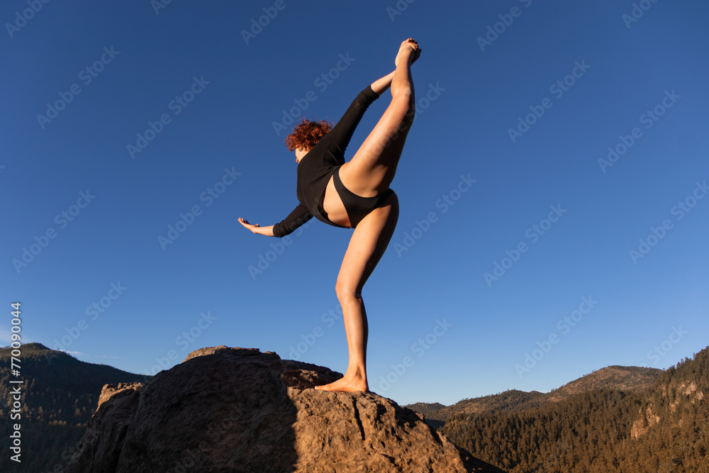 Female contemporary dancer posing on a mountain peak Female contemporary dancer posing on a mountain peak