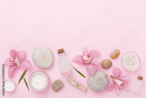 Composition with orchids, spa products on color background, top view