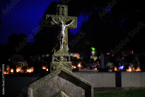 Crucified Jesus Christ on a stone cross in the cemetery, sacrificed himself for us on Easter Good Friday