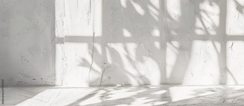 Fototapeta premium White blank poster hanging on a white wall in an empty loft room with a concrete floor and large windows, displayed as a 3D mockup render.