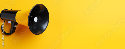 Black megaphone on yellow landscape background with copyspace 