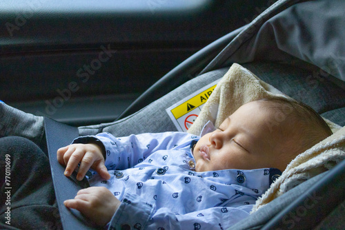 Baby lying in a car seat photo