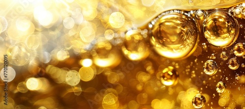 Elegant golden liquid with oil bubbles and droplets forming a captivating and luxurious background