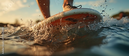 Surfer feet on a surf board on a wave