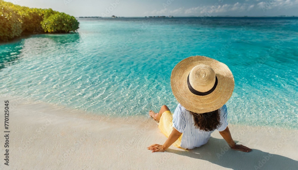 Woman in straw hat sitting on beach view from above. Summer vacation at Maldives 