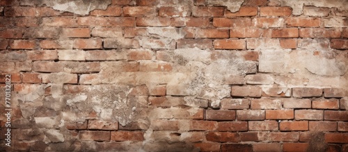 An ancient brick wall  covered in multiple fractures and chipped paint  showing signs of age and decay