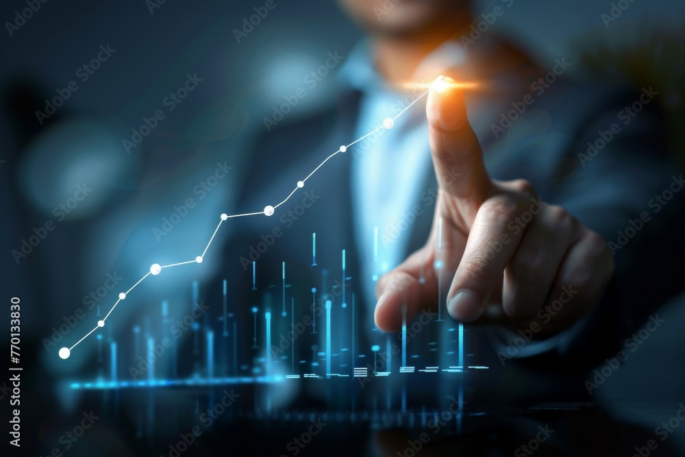 A man is pointing at a graph with a line that is rising A man is pointing at a graph with a line that is rising