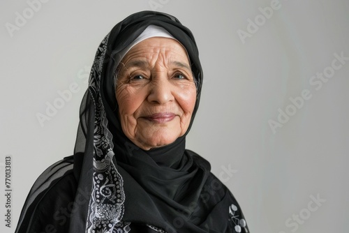 A woman wearing a black scarf and a white head scarf © top images