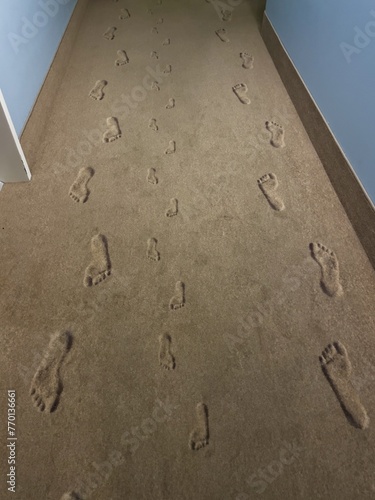 Footprints and shoe prints on a sandy path with perspective view. photo