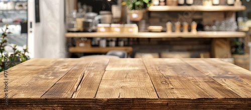 Wooden table displayed against a blurred white background, empty wooden shelf over a blurred restaurant setting, wooden tabletop for showcasing retail products in a store with a mock-up banner. © Vusal