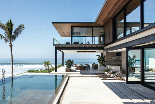 A contemporary beach house with expansive windows, a rooftop deck, and panoramic views of the ocean. © Image Studio