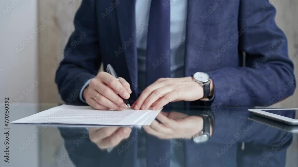 Businessman reviewing documents at office desk. Close-up of a professional man's hands examining paperwork with pen and tablet in sight. Business people concept Businessman reviewing documents at office desk. Close-up of a professional man's hands examining paperwork with pen and tablet in sight. Business people concept