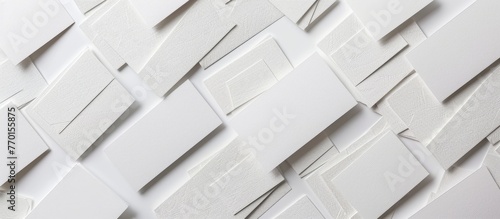 Business cards laid out horizontally in rows on a white textured paper background.