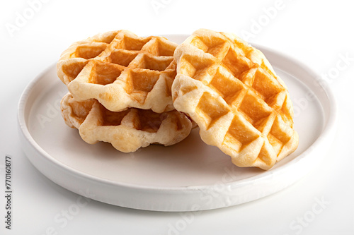 Waffles on a white plate on white background.