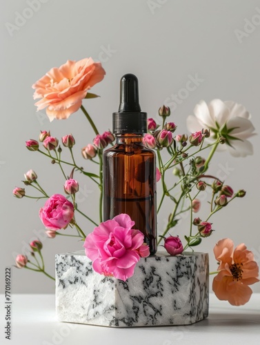 A bottle of essential oil with flowers in it