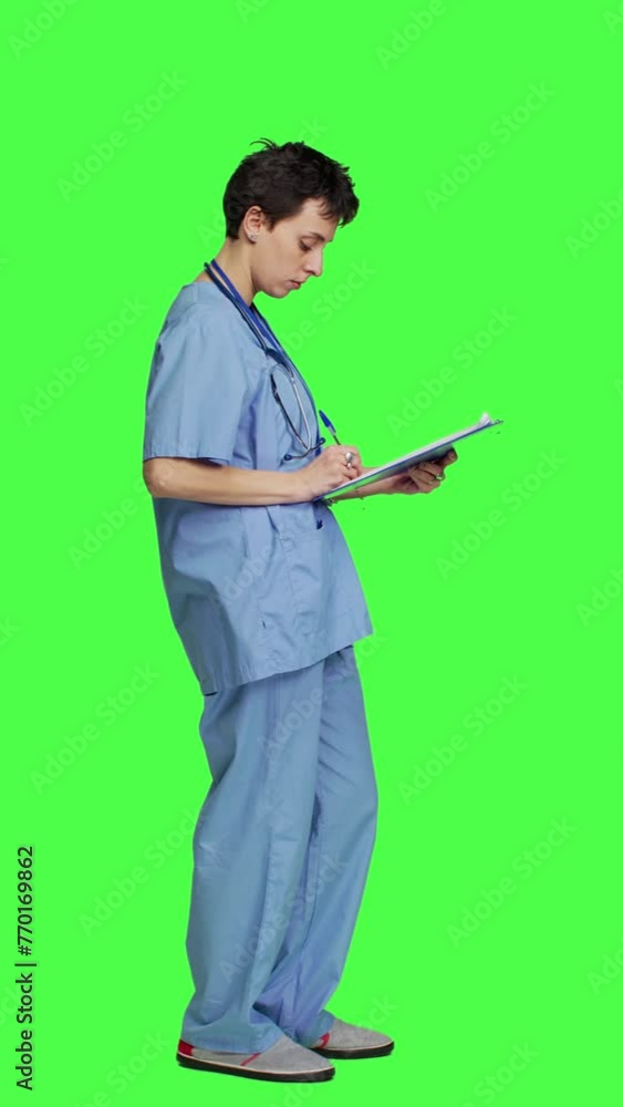 Profile Medical specialist examines x ray scan in hospital laboratory, looking at radiography to determine patient disease diagnosis. Nurse uses radiology expertise against greenscreen backdrop Profile Medical specialist examines x ray scan in hospital laboratory, looking at radiography to determine patient disease diagnosis. Nurse uses radiology expertise against greenscreen backdrop