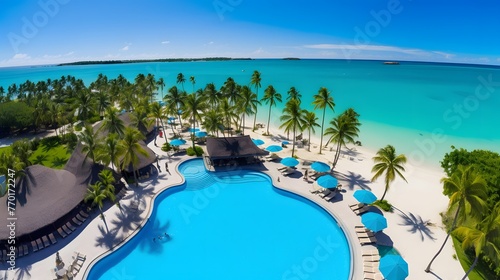 Aerial view of luxury swimming pool in tropical hotel resort with palm trees