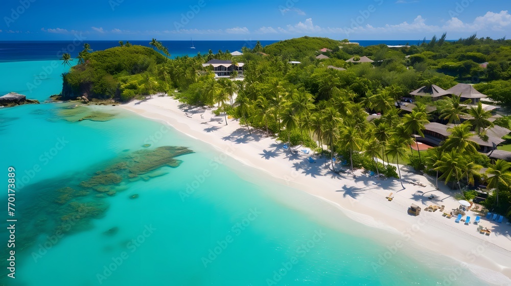 Aerial view of beautiful tropical island with white sand, turquoise water and palm trees.