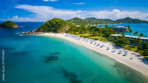 Aerial view of beautiful tropical beach with white sand, turquoise ocean water and blue sky.