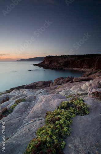 beach and rocks, Twilight, Porto Ferro, Sassari, Sardinia, Italy. Long exposure and Motion blur on waves