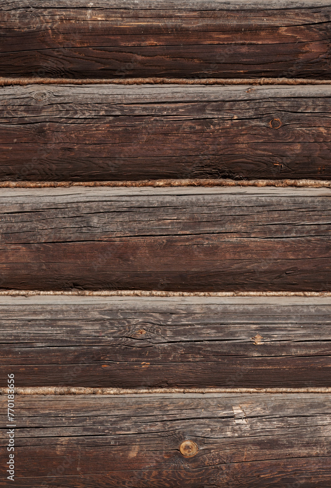 Fototapeta premium Texture of old weathered dark brown wooden log wall