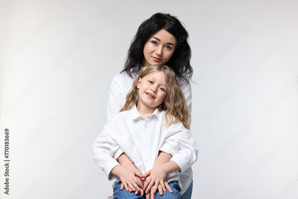 Beautiful mother with little daughter on white background Beautiful mother with little daughter on white background