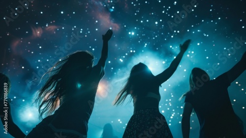 Friends dancing under a starry sky at a music festival.