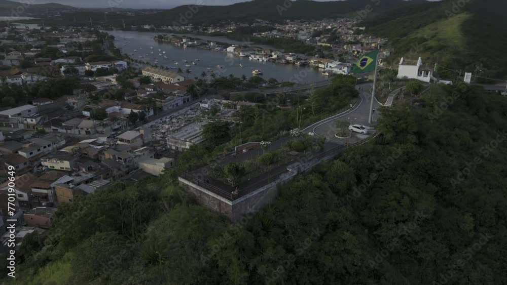 Drone orbits around viewpoint on hill in middle of city at sunset Drone orbits around viewpoint on hill in middle of city at sunset