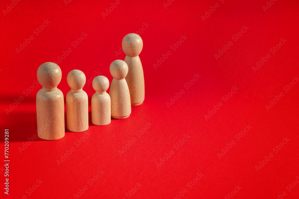 Family people figures on red background. Concept of family, values, unity, togetherness and relationship. Family people figures on red background. Concept of family, values, unity, togetherness and relationship.