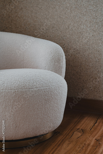 White Boulce armchair on timber floorboards in a corner