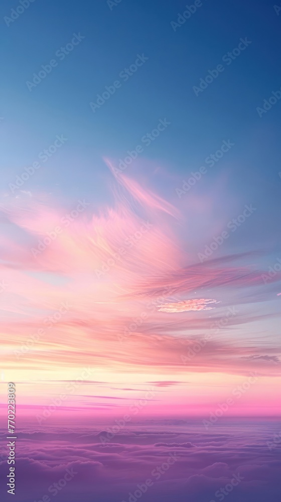 The sky is a vibrant pink and blue, with wispy clouds floating above the horizon