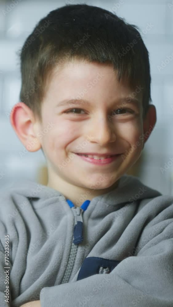 Vertical video. Close-up portrait of cute little boy looking at camera smiling, making funny mimics.
Vertical video. Close-up portrait of cute little boy looking at camera smiling, making funny mimics.