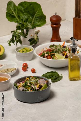 Family Vegetarian Feast with Fresh Vegetable Spread on the Dinner Table showcasing fresh vegetables, complemented by olive oil, wine, pepper, and assorted ingredients as lettuce, tomato, avocado
