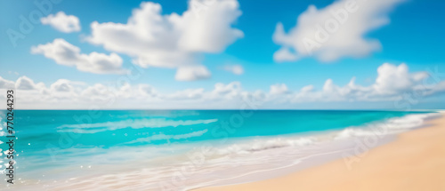 Abstract defocused background. Tropical summer beach with golden sand  turquoise ocean and blue sky with white clouds on bright sunny day. Summer holidays concept.
