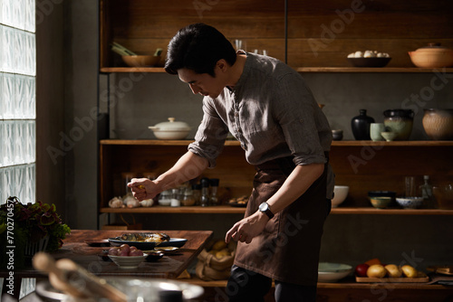 Cook making dishes in the kitchen photo