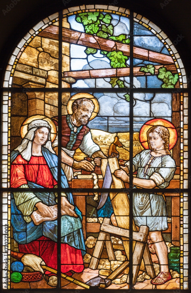 MILAN, ITALY - MARCH 6, 2024: The Holy Family in the stained glass of the church Chiesa del Redentore by unknown artist (1933).