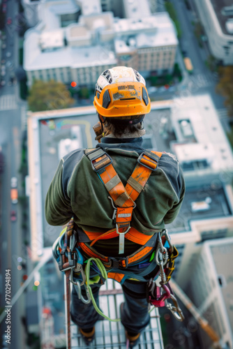 Construction worker at a high place, wearing a safety harness