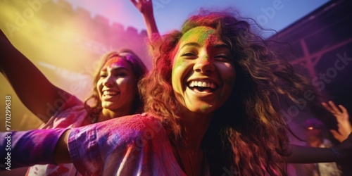 Two women are smiling and dancing in the air. They are wearing colorful clothes and have their hair in a messy bun. Scene is joyful and celebratory
