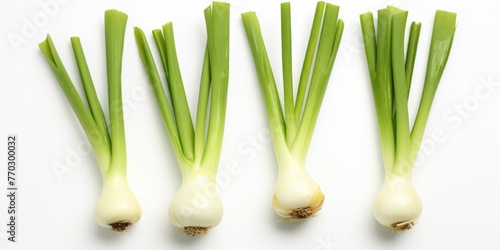 Four green onions are displayed on a white background. The onions are fresh and ready to be used in a meal