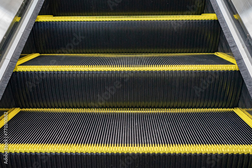 Escalator floor with copy space. Close up of the metal steps of a typical escalator. Staircase, Steps, Three Objects, Single Step, Motion