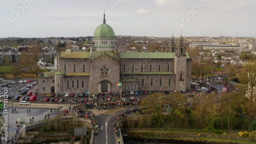 Aerial static shot of Galway Cathedral. Crowded street waiting for Sanit Patrick's day parade. photo