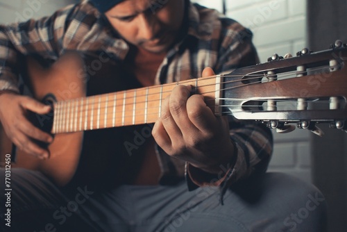 latin man practicing acoustic guitar © Rodrigo