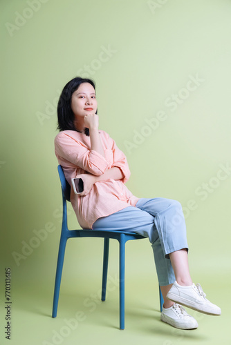 Photo of young Asian woman on background