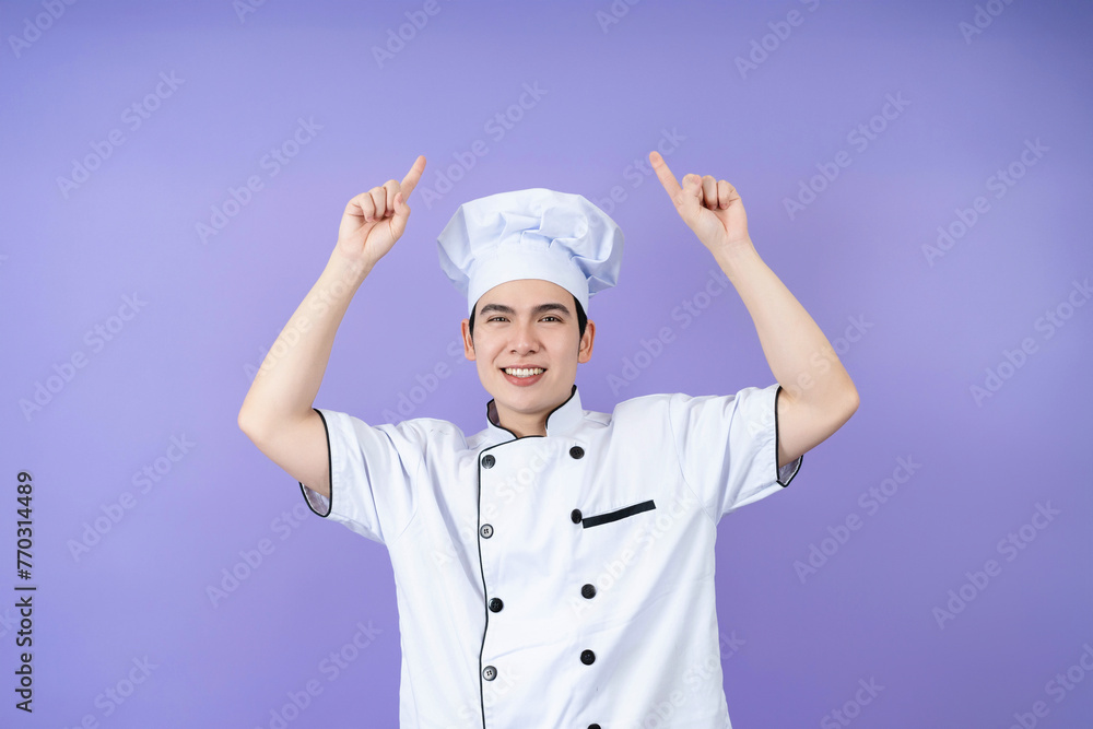 Young Asian male chef on background