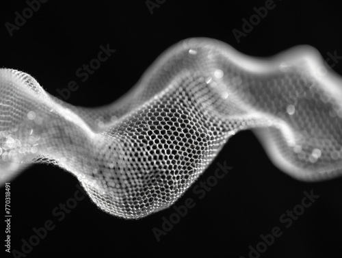 A black and white image of a wire-like object with a white background. The image has a futuristic and abstract feel to it