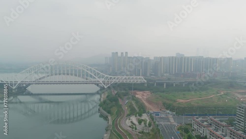 top view of high-speed train, city, train on the tracks in Nanning city, China. Aerial view and low angle footage using a drone camera. photo