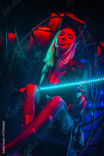 Beautiful futuristic girl posing with light sword katana in the neon lights. Cyberpunk concept. © Dmitriy